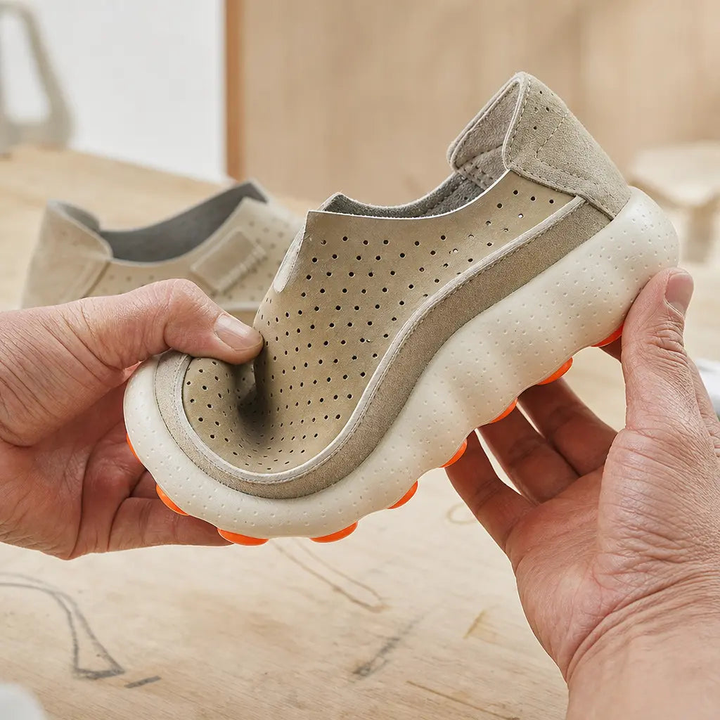 A flexible pod-grip loafer bending under light hand pressure